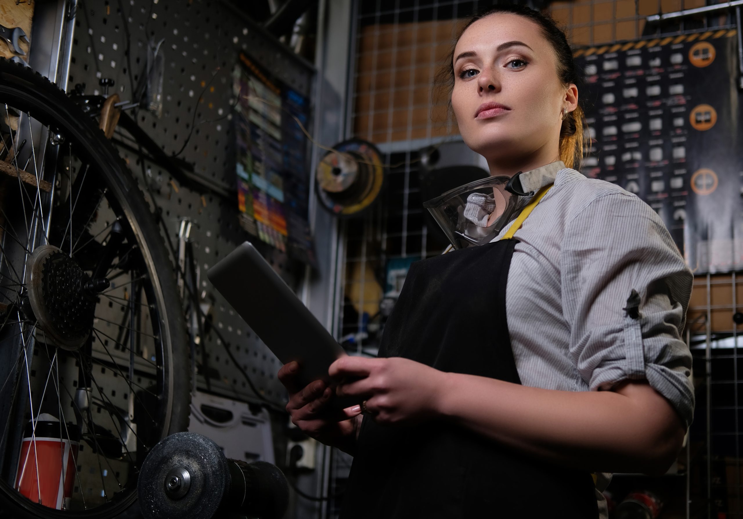 portrait beautiful brunette female wearing working clothes apron goggles holds tablet computer workshop scaled
